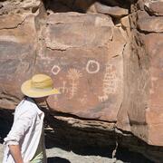 Examining petroglyphs in Desolation Canyon