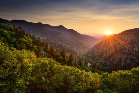 View of mountains with sun over the mountains