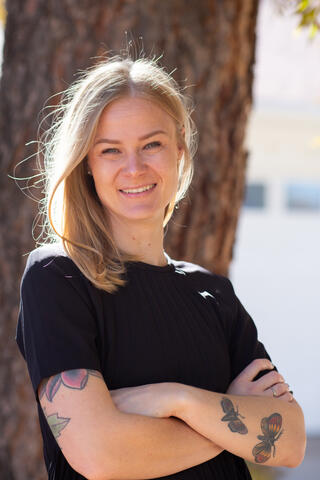 Dr. Cassie Boness wearing a black top with arms crossed.