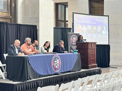 A panel containing Prof. Mourning and others.