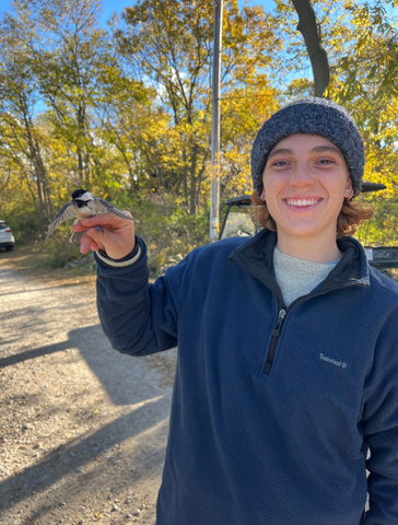 Elena Delach holding a Black-capped Chickadee