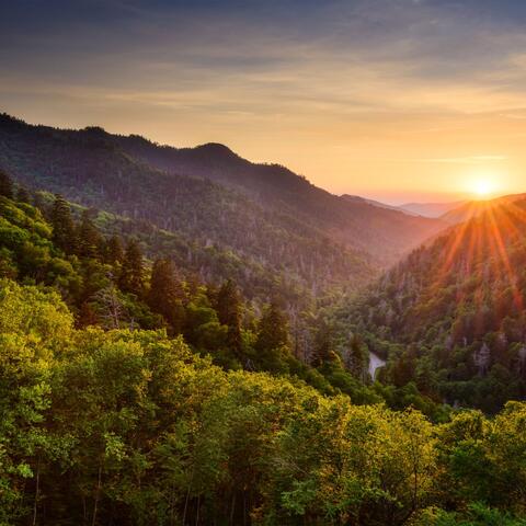 View of mountains with sun over the mountains