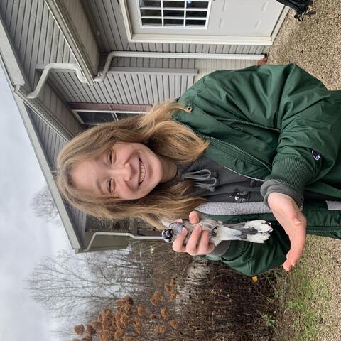 Biz Savitski holding a Blue Jay